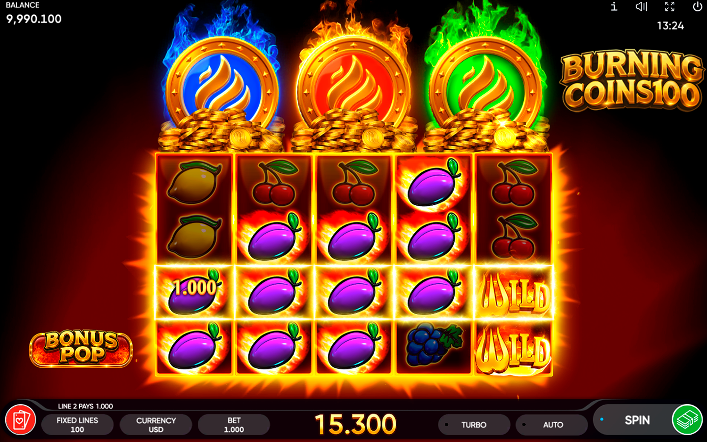 Burning Coins 100 gameplay with glowing fruit wins, stacked Wild symbols, flaming bonus coins, and a 15,300-credit win.