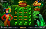 Joker Miner gameplay screenshot showing a female jester beside a green gemstone selection board surrounded by glowing emerald crystals.